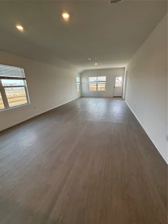 an empty room with windows and entrance