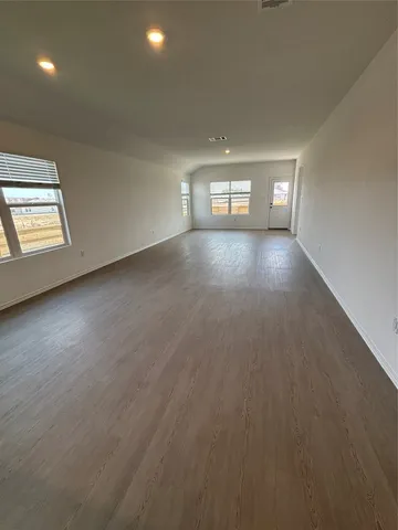 an empty room with windows and entrance