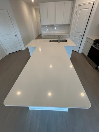 a kitchen with stainless steel appliances a refrigerator microwave and sink