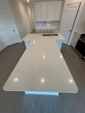 a kitchen with stainless steel appliances a refrigerator microwave and sink