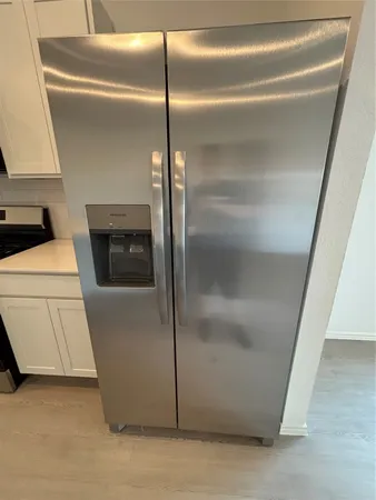 a view of water heater room with a ceiling fan