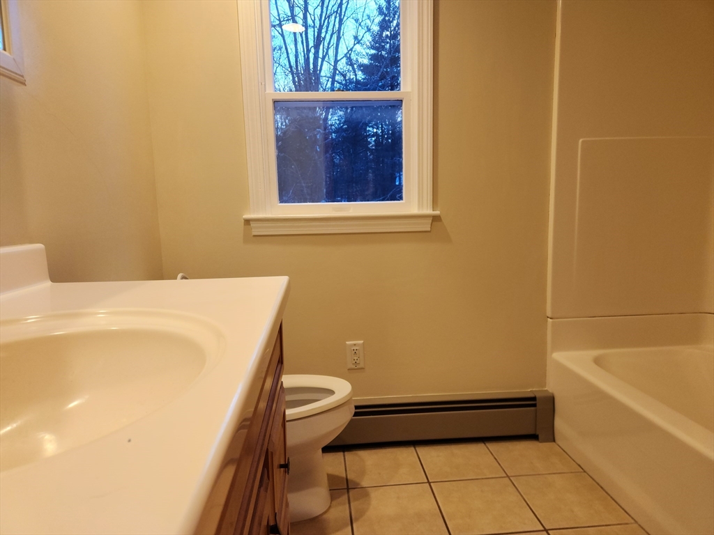 17 Diamond Hill Road, Unit B Jefferson, MA 01522 - Photo 6 of 8 a bathroom with a sink a toilet and bathtub