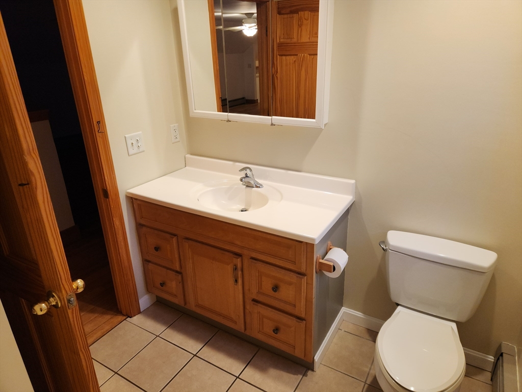 17 Diamond Hill Road, Unit B Jefferson, MA 01522 - Photo 7 of 8 a bathroom with a toilet sink and mirror