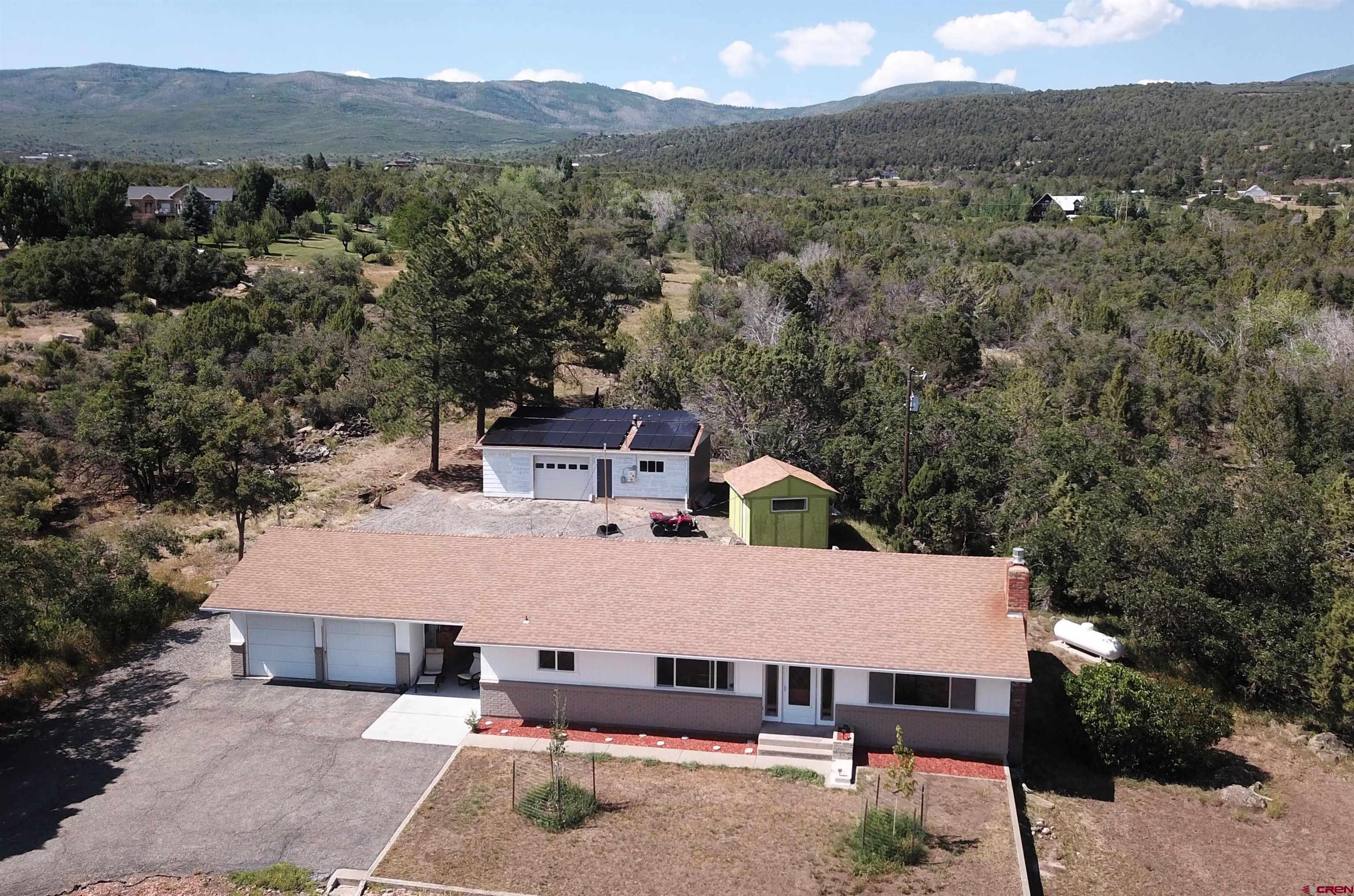 an aerial view of a house with a yard