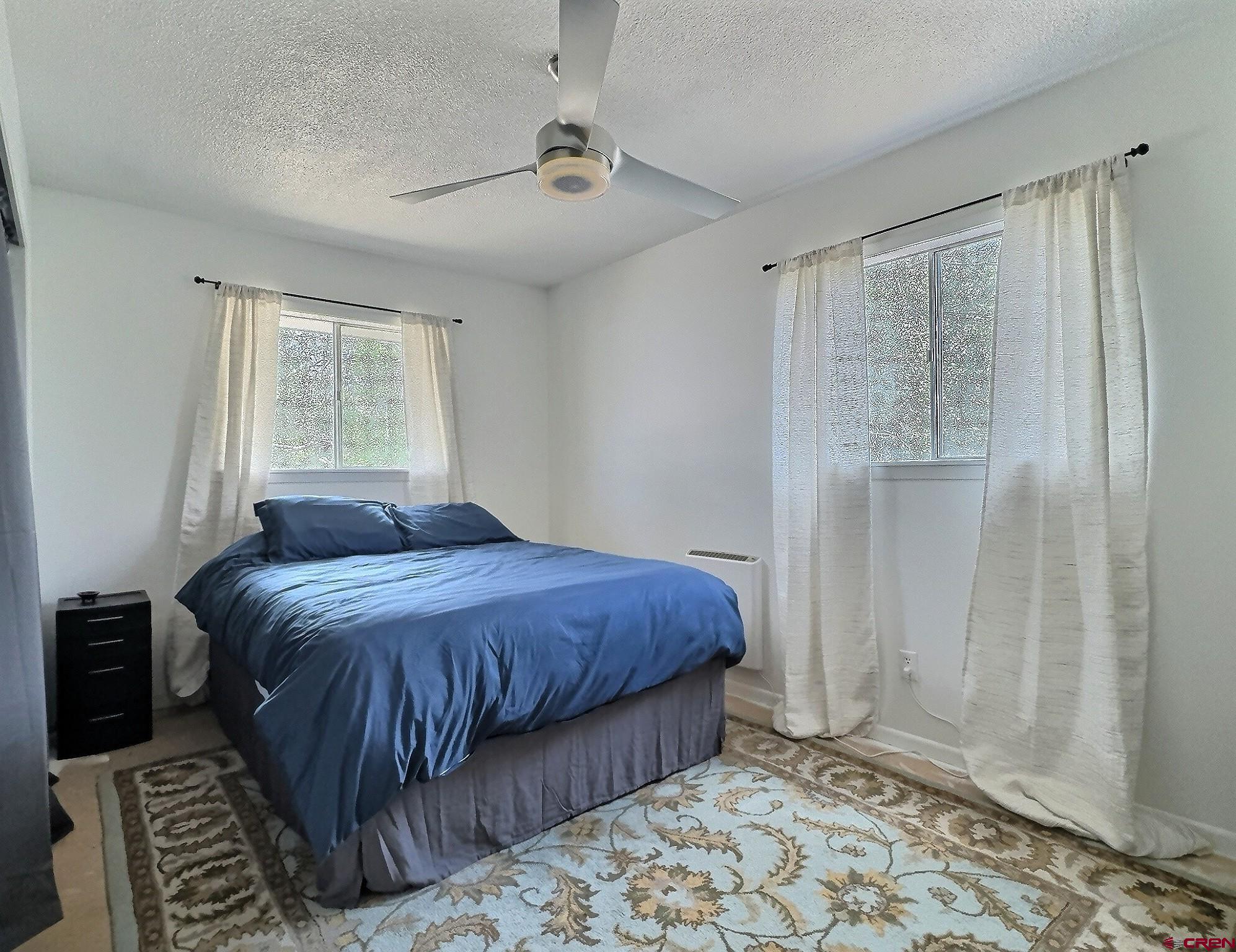 22755 Uintah Road Cedaredge, CO 81413 - Photo 11 of 21 a bedroom with a bed and a window