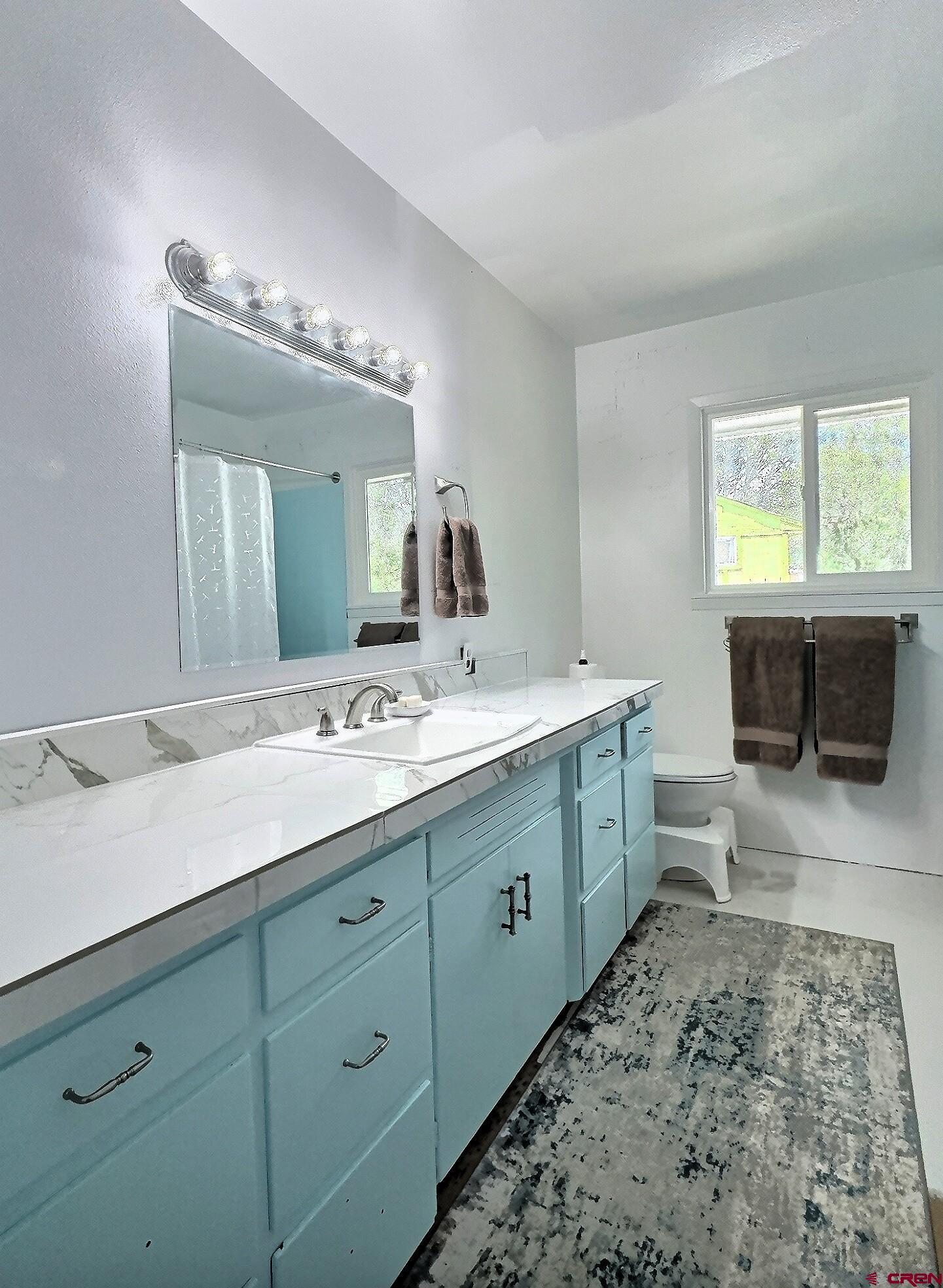 22755 Uintah Road Cedaredge, CO 81413 - Photo 12 of 21 a bathroom with a double vanity sink and a mirror