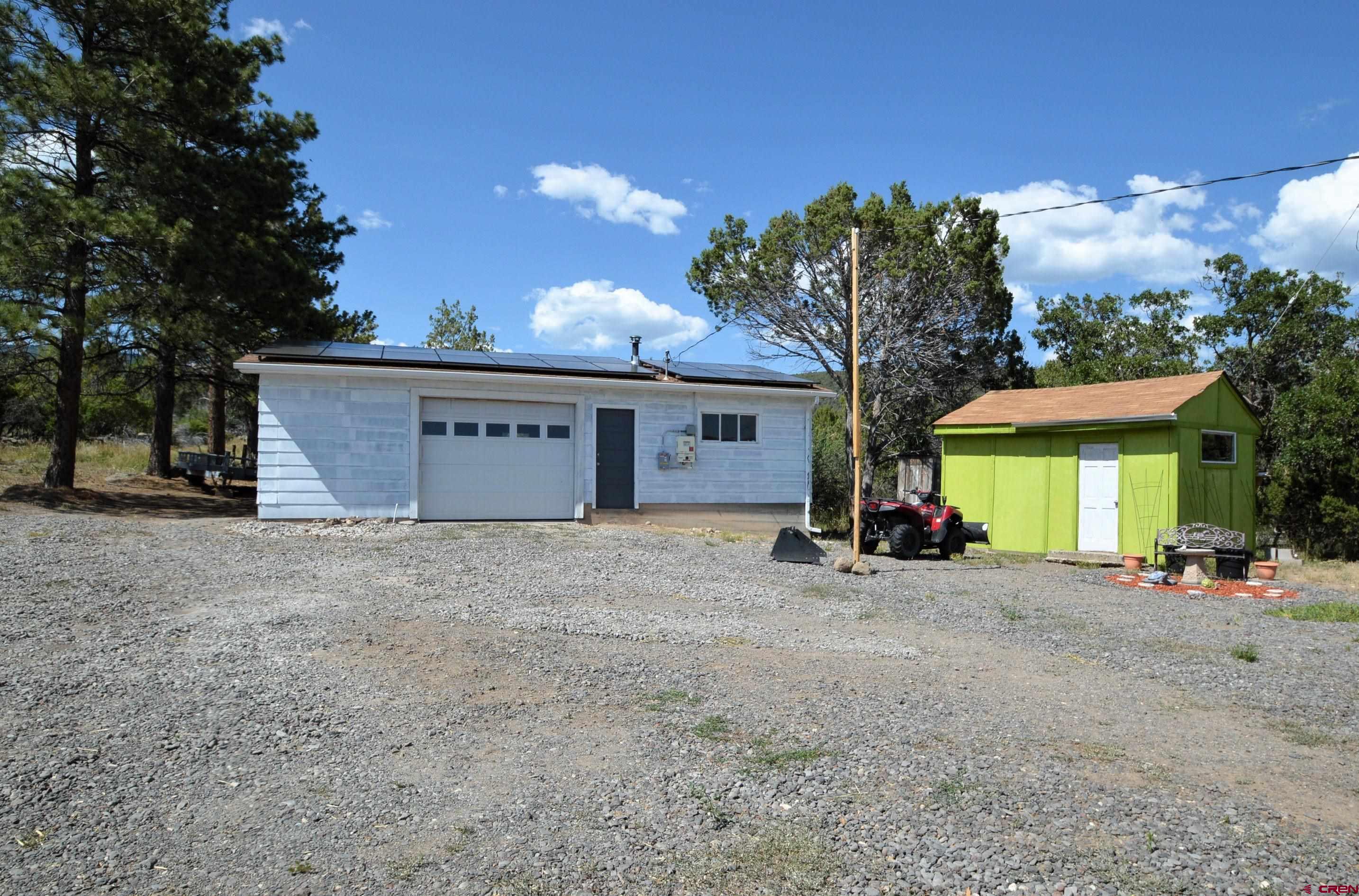 22755 Uintah Road Cedaredge, CO 81413 - Photo 18 of 21 a view of a house with a outdoor space and a tree
