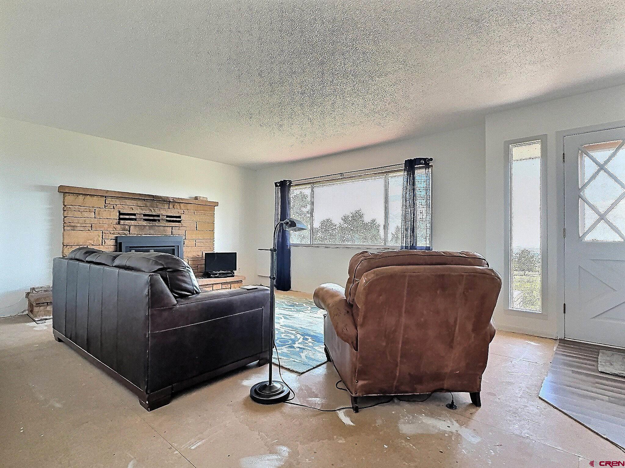 22755 Uintah Road Cedaredge, CO 81413 - Photo 8 of 21 a living room with furniture and a window