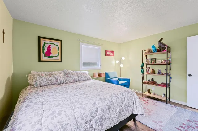 a bedroom with a bed and a bookshelf