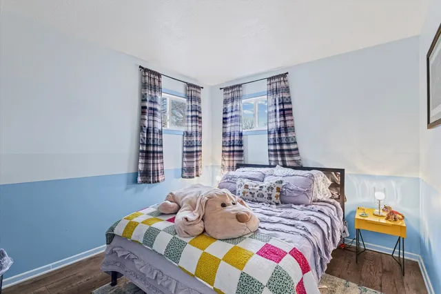 a bedroom with a bed and a chair