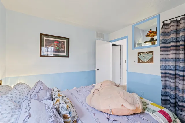 a bedroom with a bed and a chair