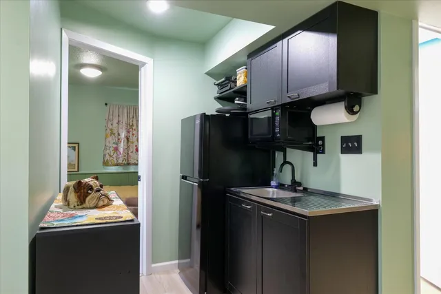 a kitchen with a sink stove and refrigerator