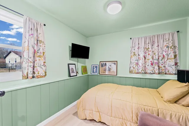 a bedroom with a bed and a flat screen tv