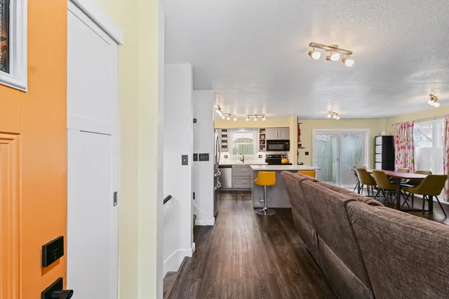 a view of a living room with furniture and wooden floor