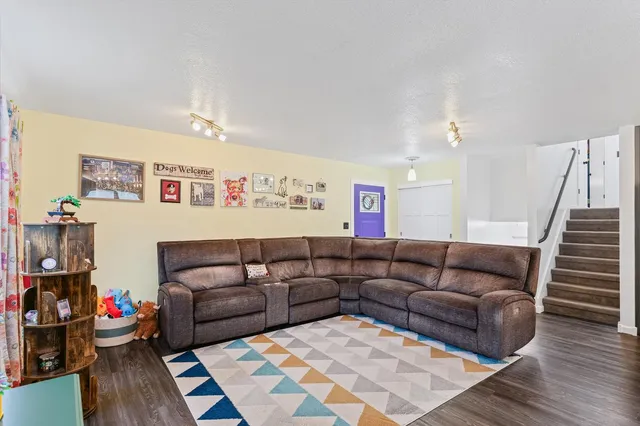 a living room with furniture and wooden floor