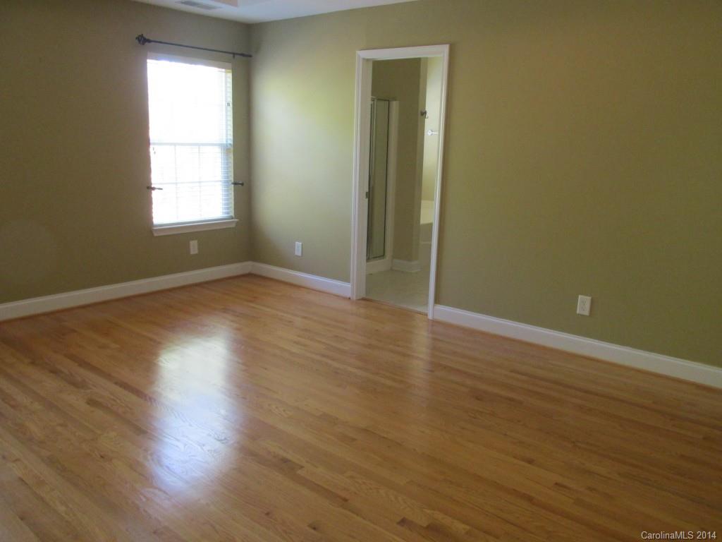 1842 Sam Smith Road, Unit 7 Fort Mill, SC 29708 - Photo 14 of 16 an empty room with wooden floor and windows