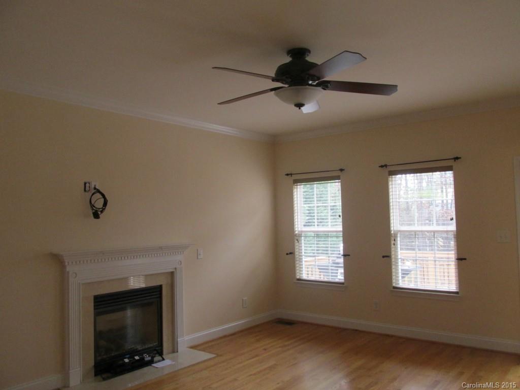 1842 Sam Smith Road, Unit 7 Fort Mill, SC 29708 - Photo 7 of 16 a view of an empty room with a fireplace and a window