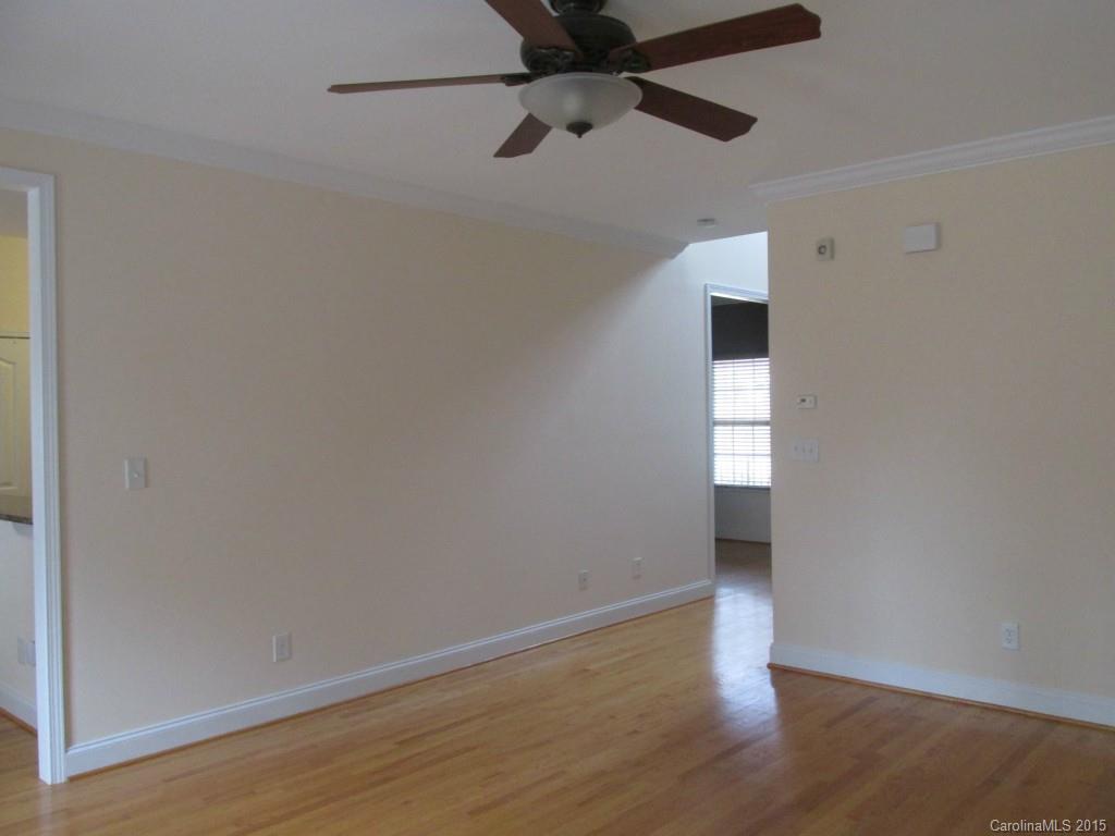 1842 Sam Smith Road, Unit 7 Fort Mill, SC 29708 - Photo 8 of 16 a view of an empty room with wooden floor and a window