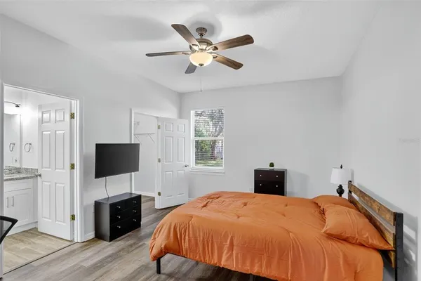 a bedroom with a bed and flat screen tv