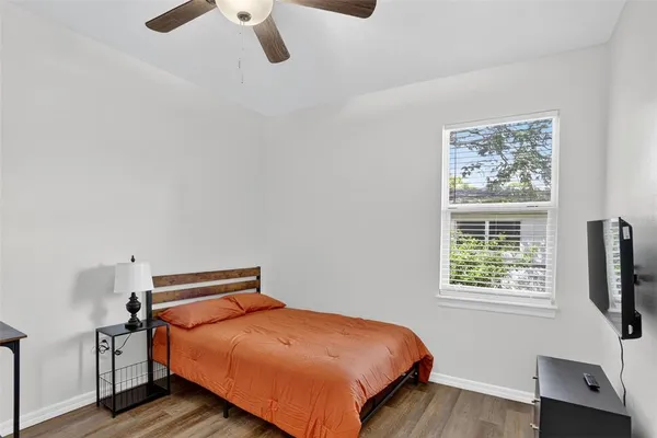 a bedroom with a bed and window