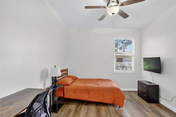 a bedroom with a bed and a flat screen tv