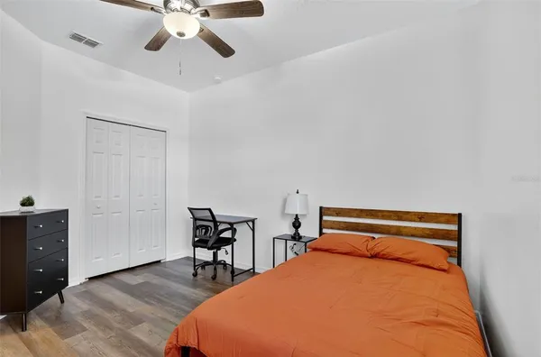 a bedroom with a bed and a dresser