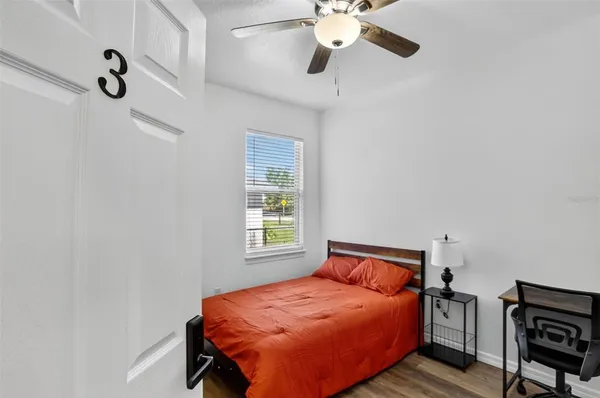 a bedroom with a bed and a chandelier