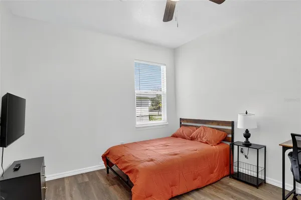 a bedroom with a bed and flat screen tv