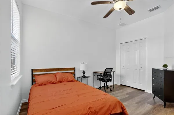 a bedroom with a bed and a chandelier