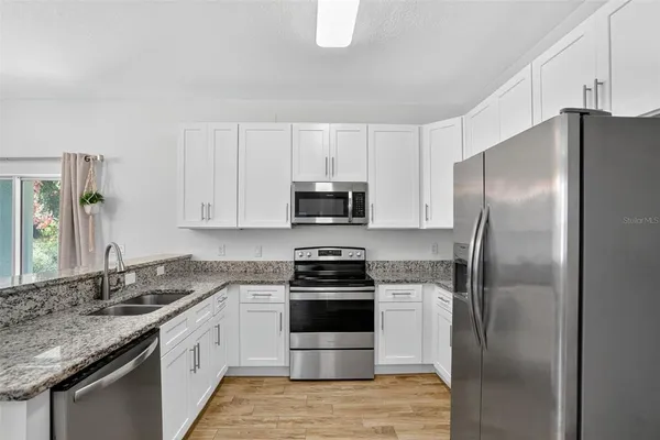 a kitchen with a sink stove and refrigerator