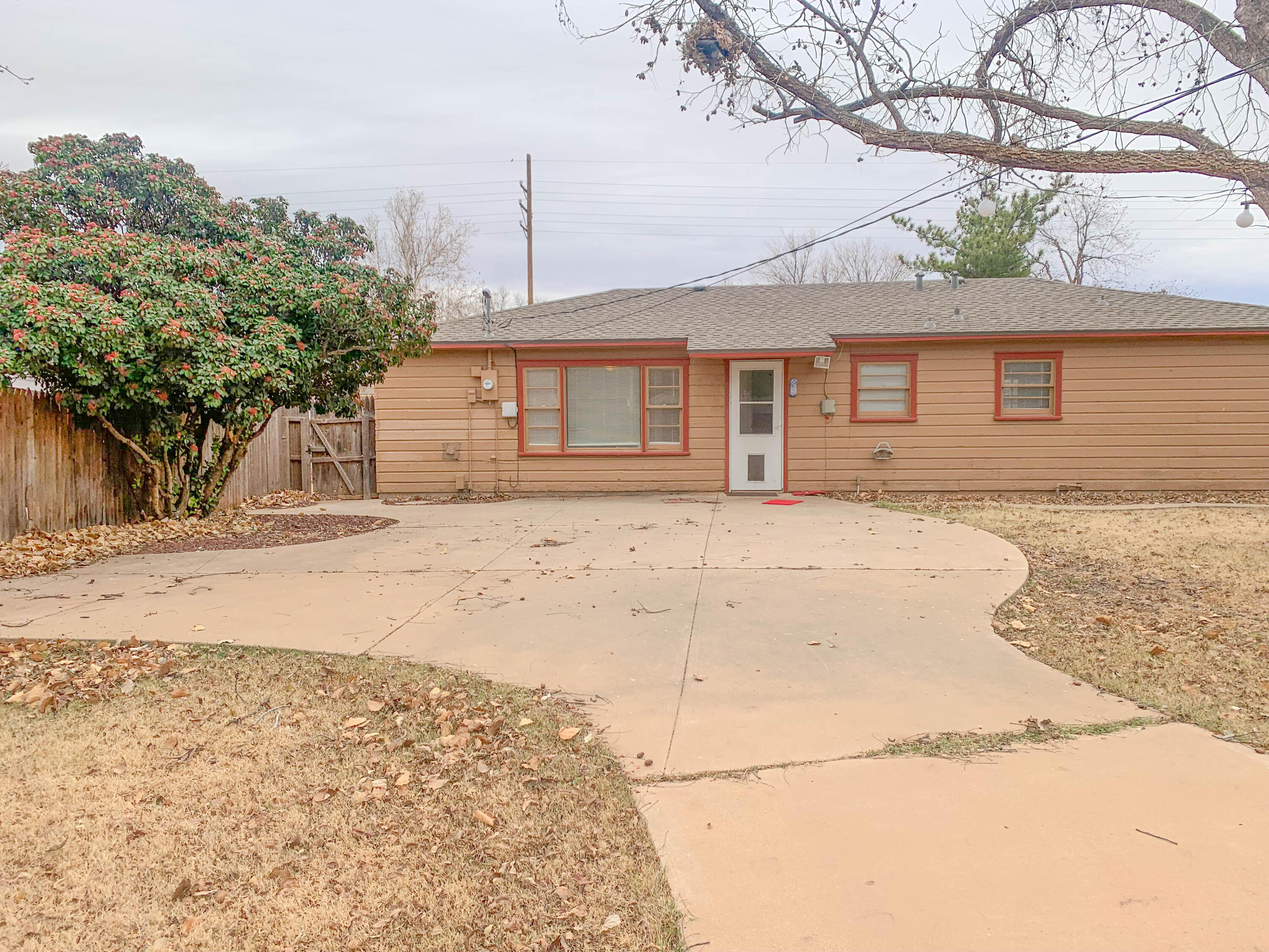 4315 42nd Street Lubbock, TX 79413 - Photo 11 of 11 a house that has a tree in front of it