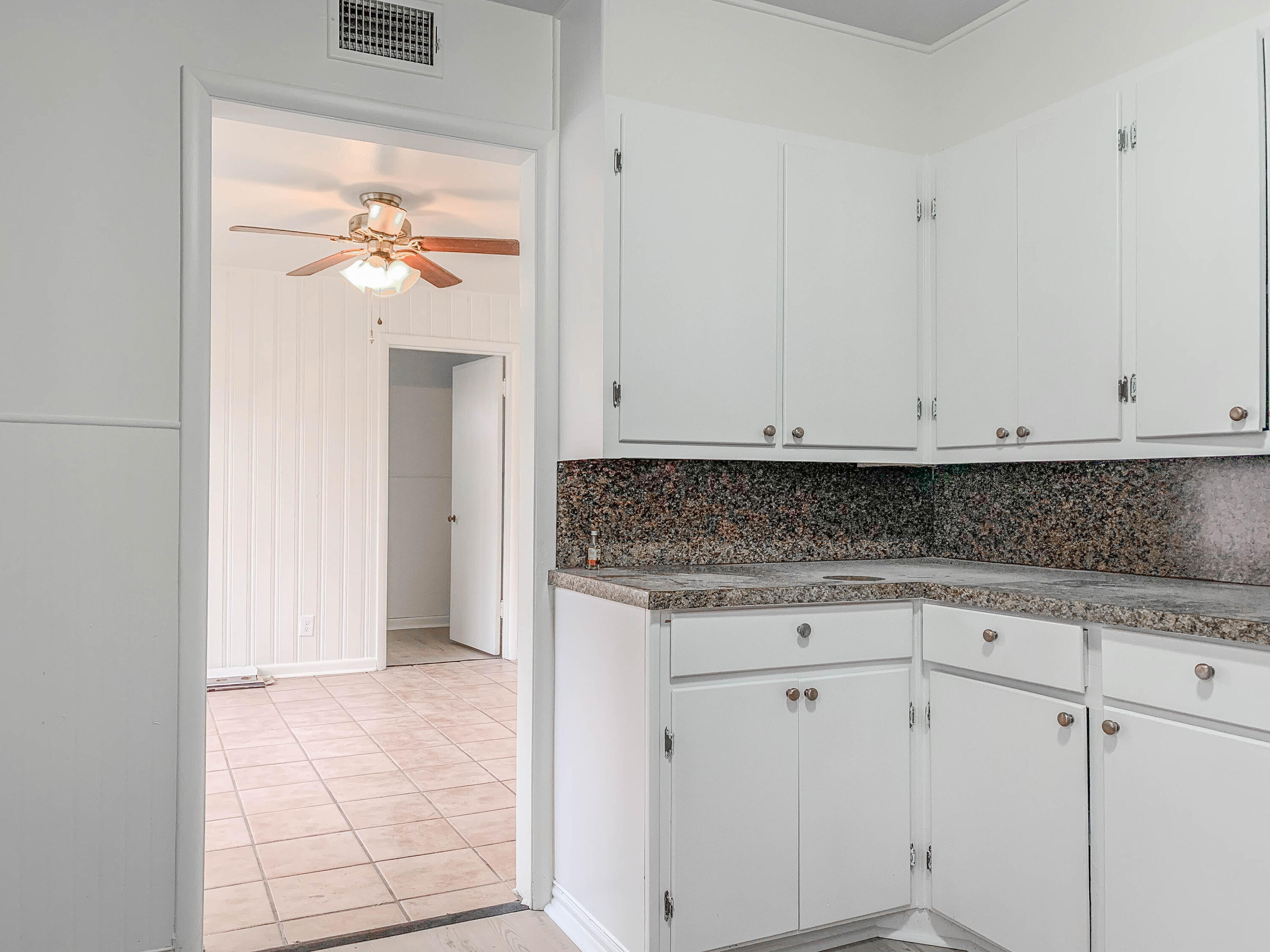 4315 42nd Street Lubbock, TX 79413 - Photo 5 of 11 a view white cabinets and a painting on the wall
