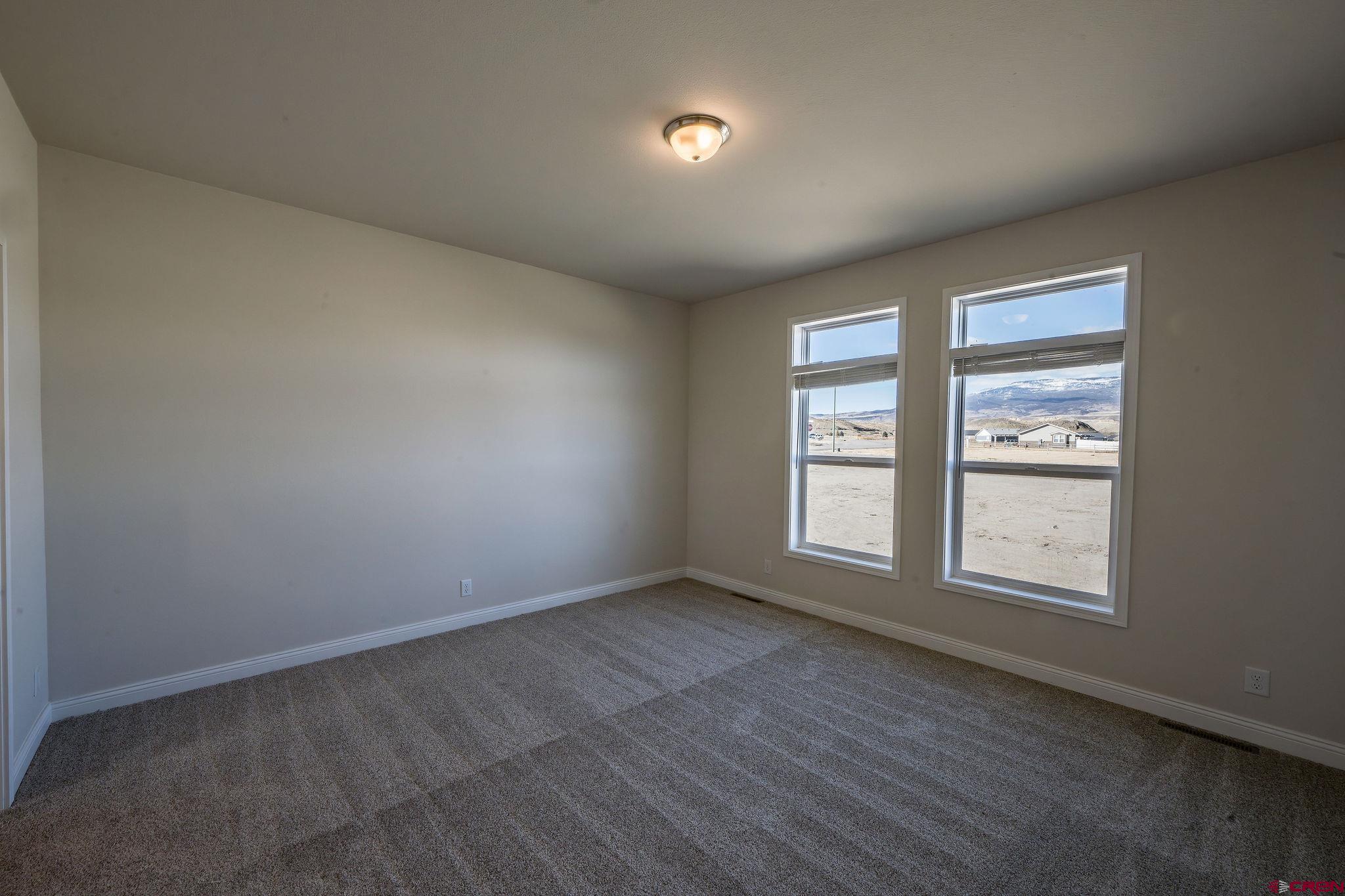 1230 H25 Road Delta, CO 81416 - Photo 18 of 34 an empty room with wooden floor and windows