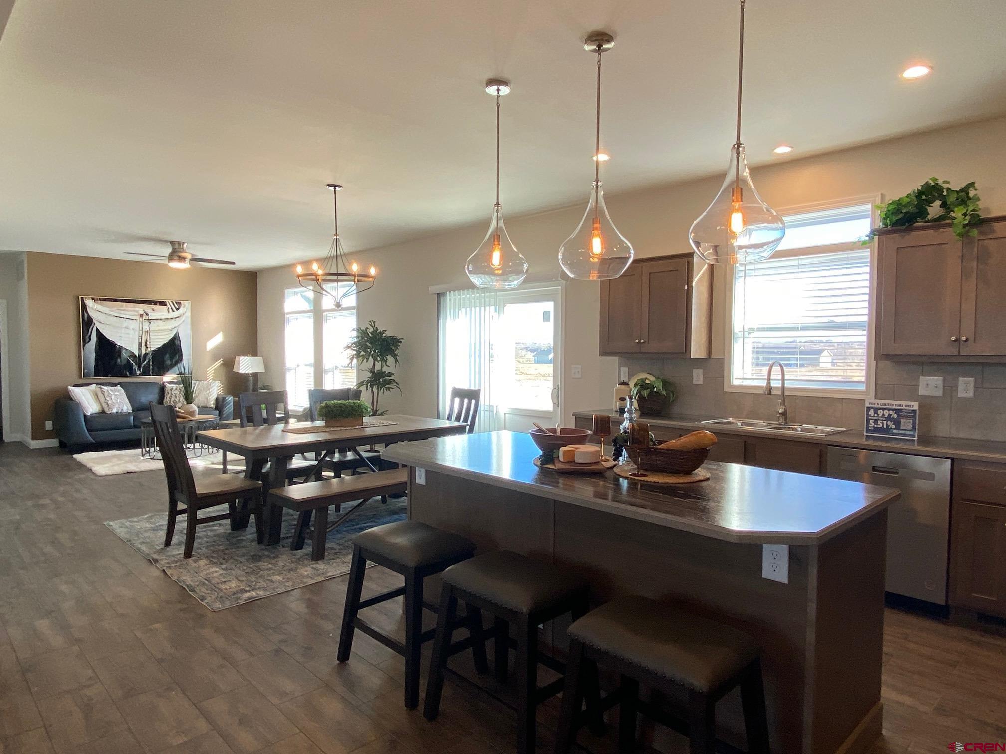 1230 H25 Road Delta, CO 81416 - Photo 7 of 34 a kitchen with a dining table chairs sink and stove