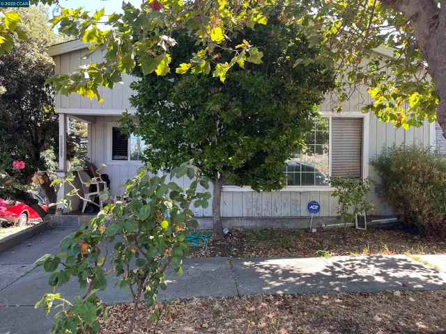 a front view of a house with a yard and a garden