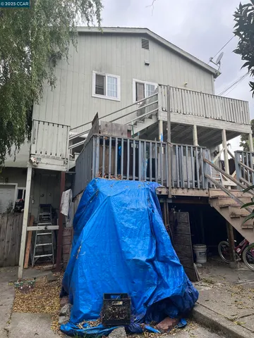 a view of roof deck with wooden floor and fence