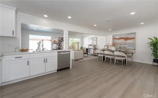 a large white kitchen with a large window