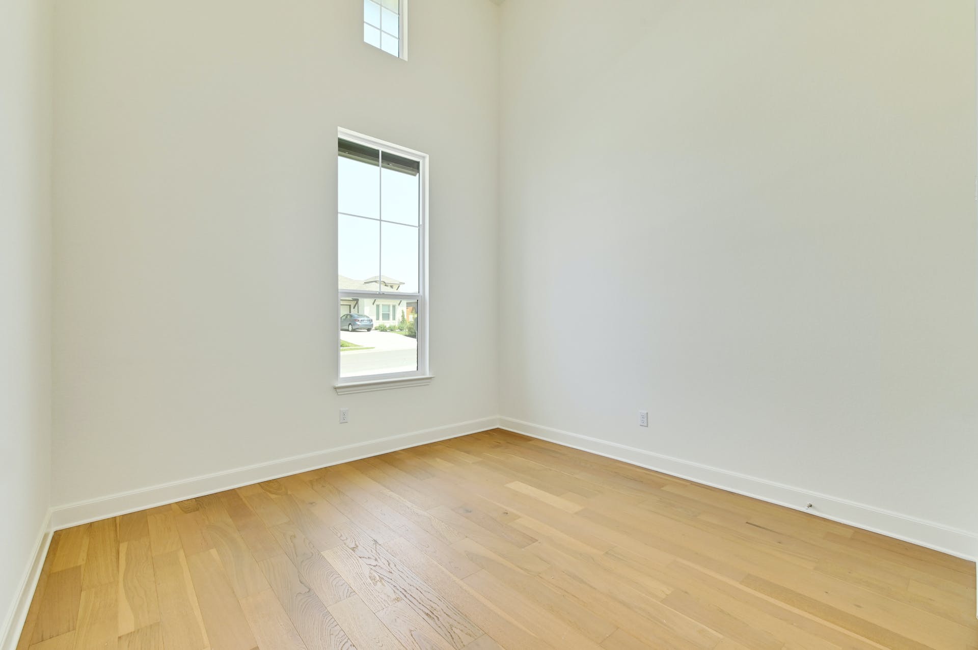 19005 Fernando Trail Austin, TX 78738 - Photo 28 of 35 Third Bedroom downstair with two story ceiling and double windows, filled with light, wood-style floors