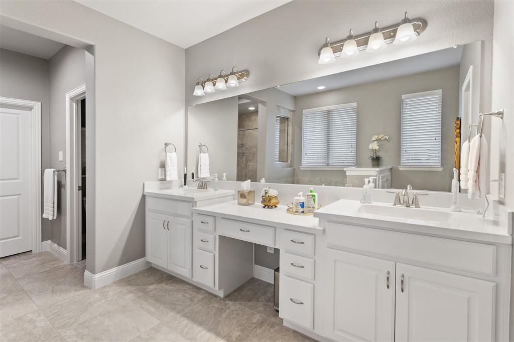 1003 Fenwick Lane Forney, TX 75126 - Photo 12 of 39 a spacious bathroom with a double vanity sink mirror and