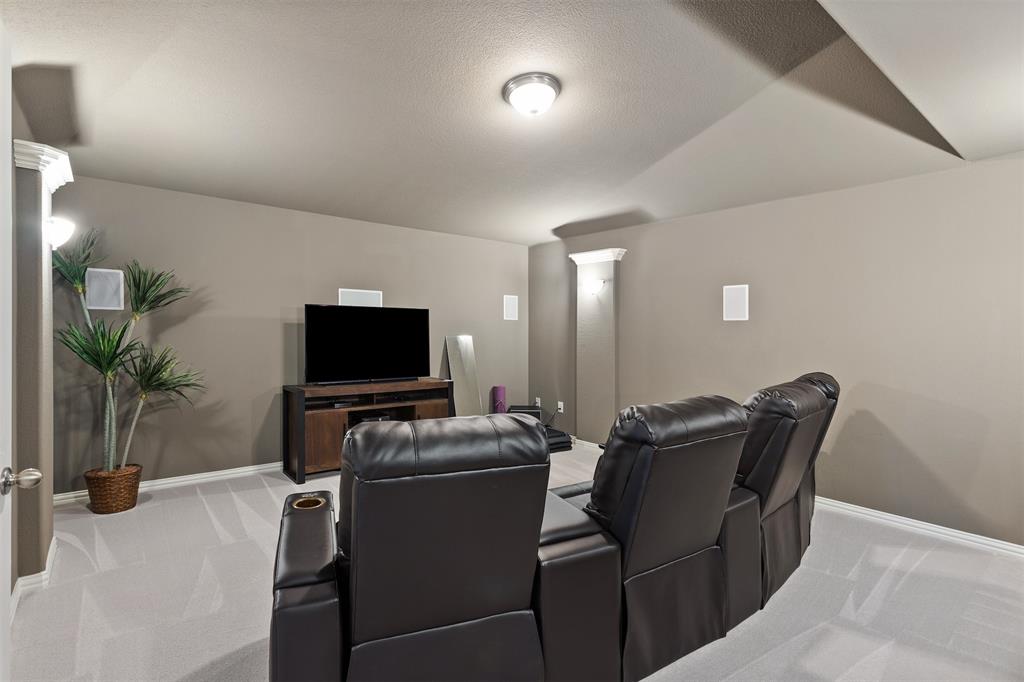 1003 Fenwick Lane Forney, TX 75126 - Photo 23 of 39 a living room with furniture and a flat screen tv