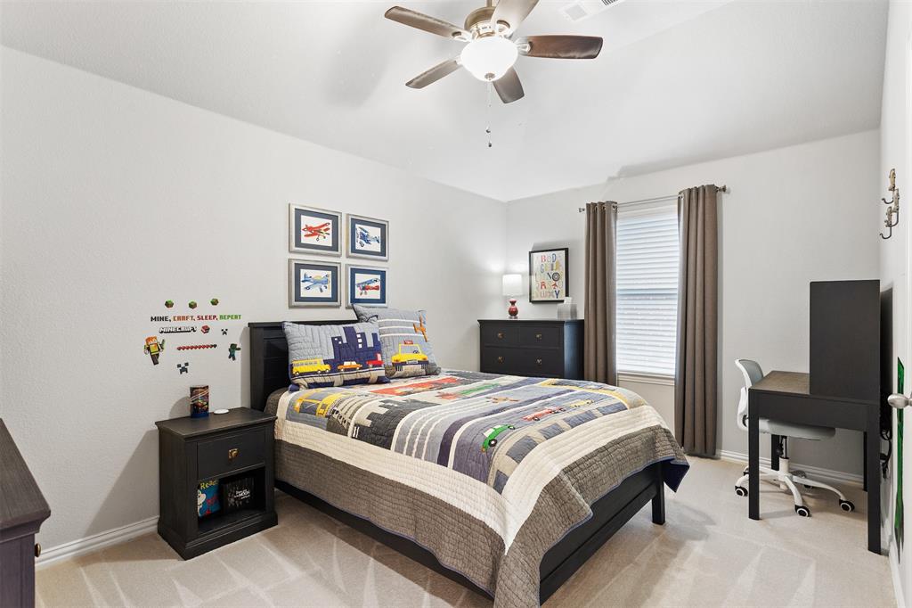 1003 Fenwick Lane Forney, TX 75126 - Photo 28 of 39 a bedroom with a bed and a flat screen tv