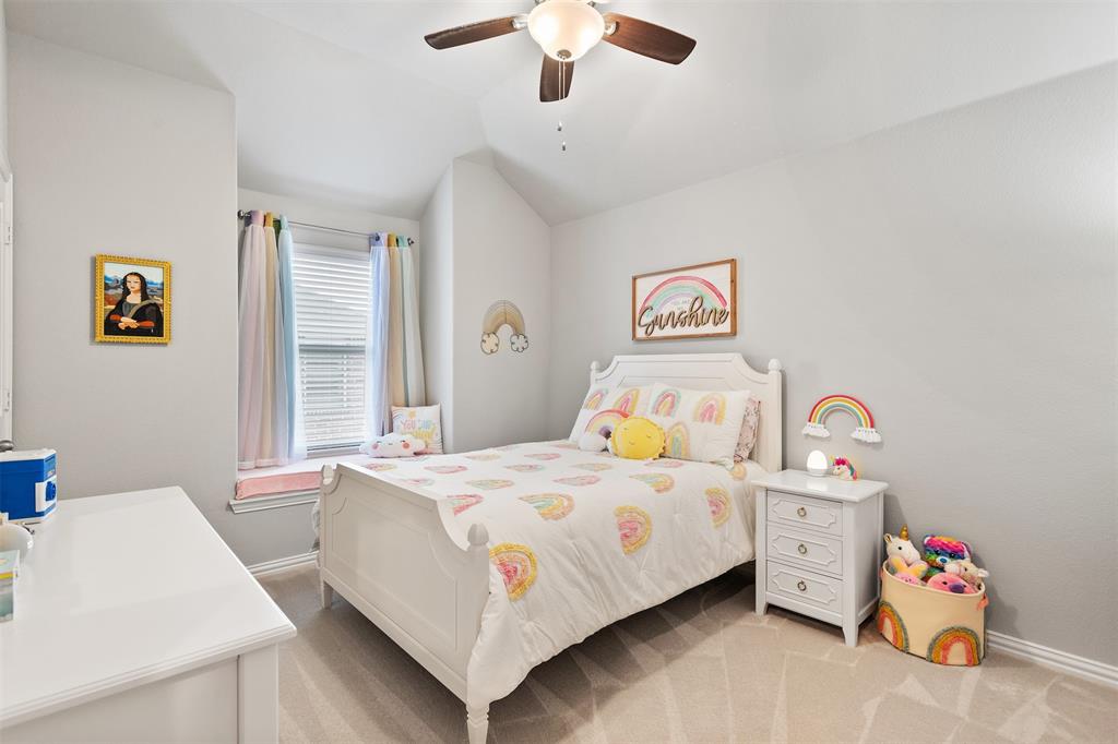 1003 Fenwick Lane Forney, TX 75126 - Photo 29 of 39 a bedroom with a bed and a chandelier