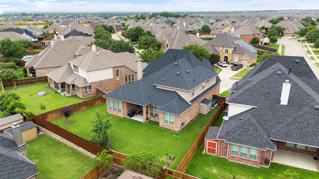 1003 Fenwick Lane Forney, TX 75126 - Photo 3 of 39 an aerial view of multiple houses with a yard