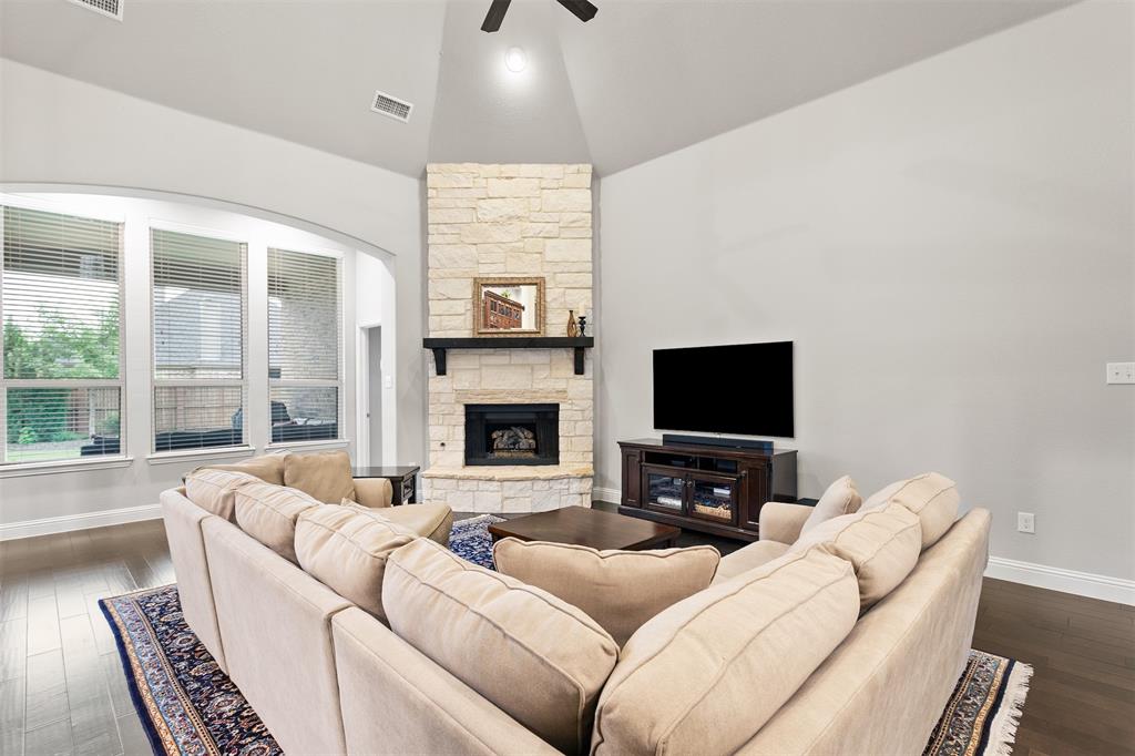 1003 Fenwick Lane Forney, TX 75126 - Photo 7 of 39 a living room with furniture flat screen tv and a fireplace