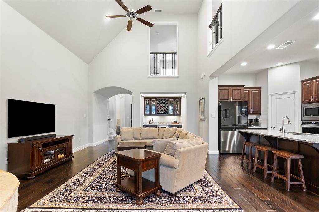 1003 Fenwick Lane Forney, TX 75126 - Photo 10 of 39 a living room with furniture a rug a flat screen tv and a table