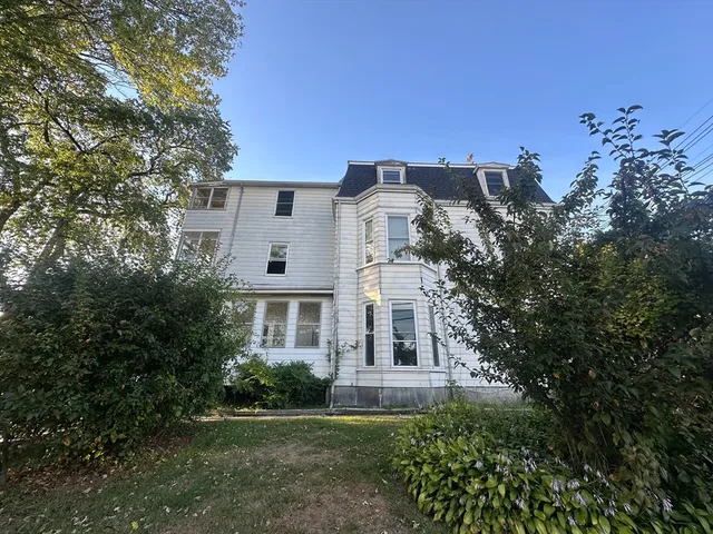 a view of a house with a backyard