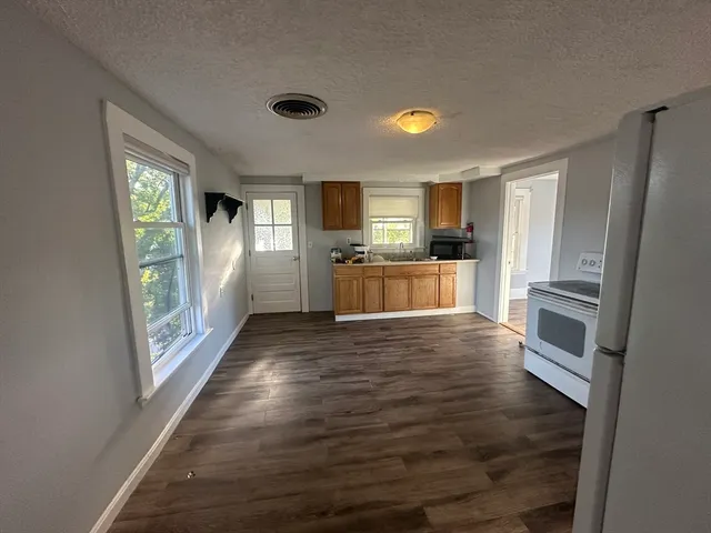 a kitchen with a refrigerator and a stove top oven