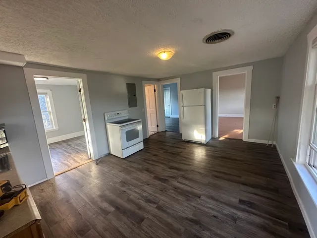 wooden floor in an empty room with a fireplace