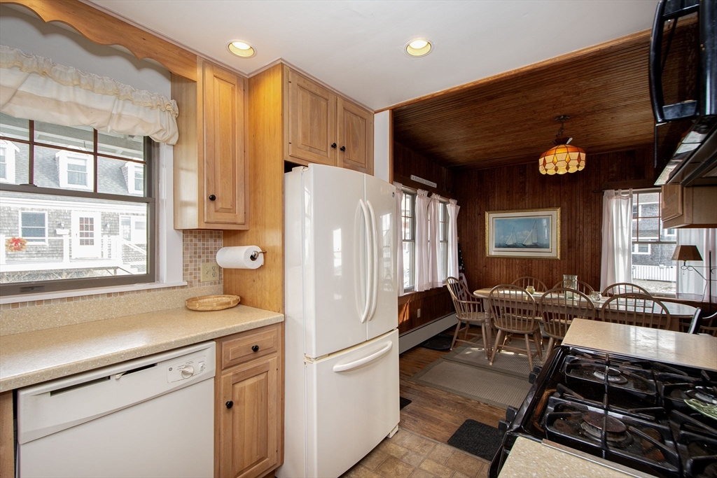 42 Lighthouse Road Scituate, MA 02066 - Photo 13 of 27 a kitchen with stainless steel appliances a refrigerator a stove and a sink