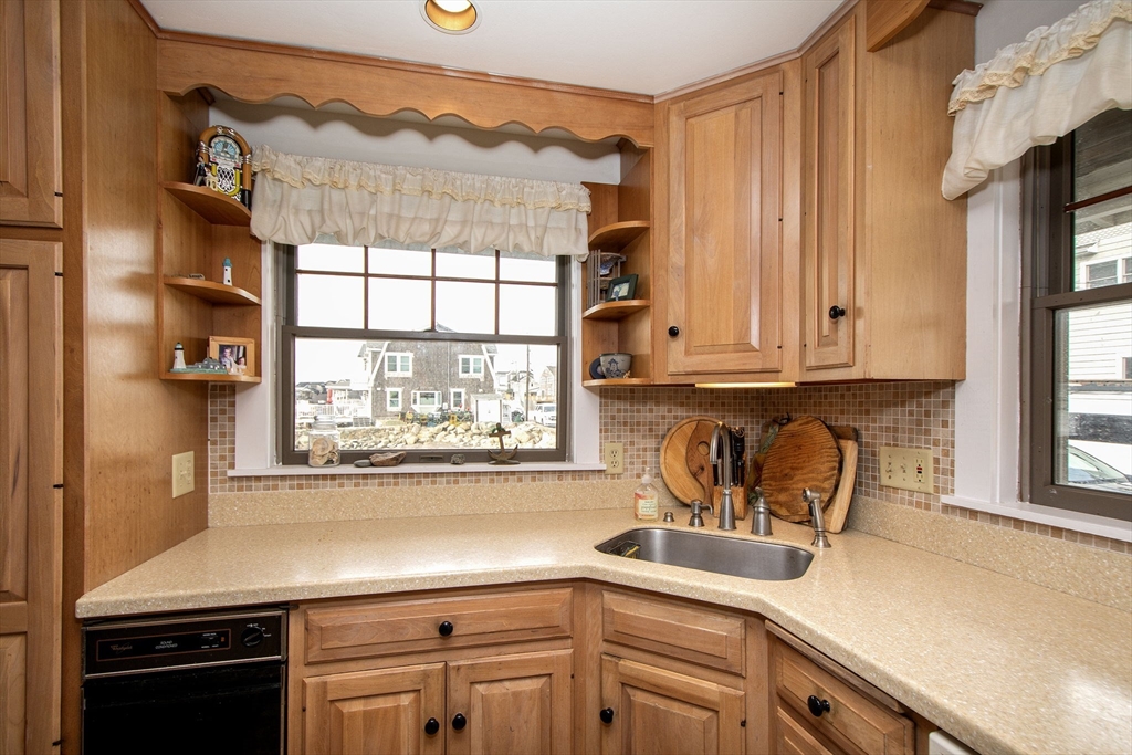 42 Lighthouse Road Scituate, MA 02066 - Photo 14 of 27 a kitchen with stainless steel appliances a sink a stove and a window